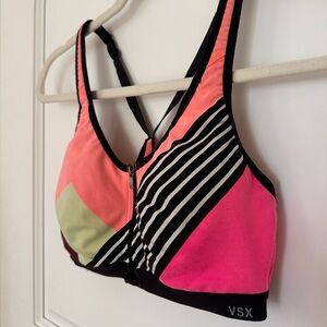 Victoria’s Secret sports bra with built-in bra. Neon pinks and orange. Size 34B.